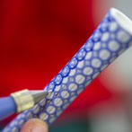 Rhian Malin decorating a mandala bottle in her workshop 2019